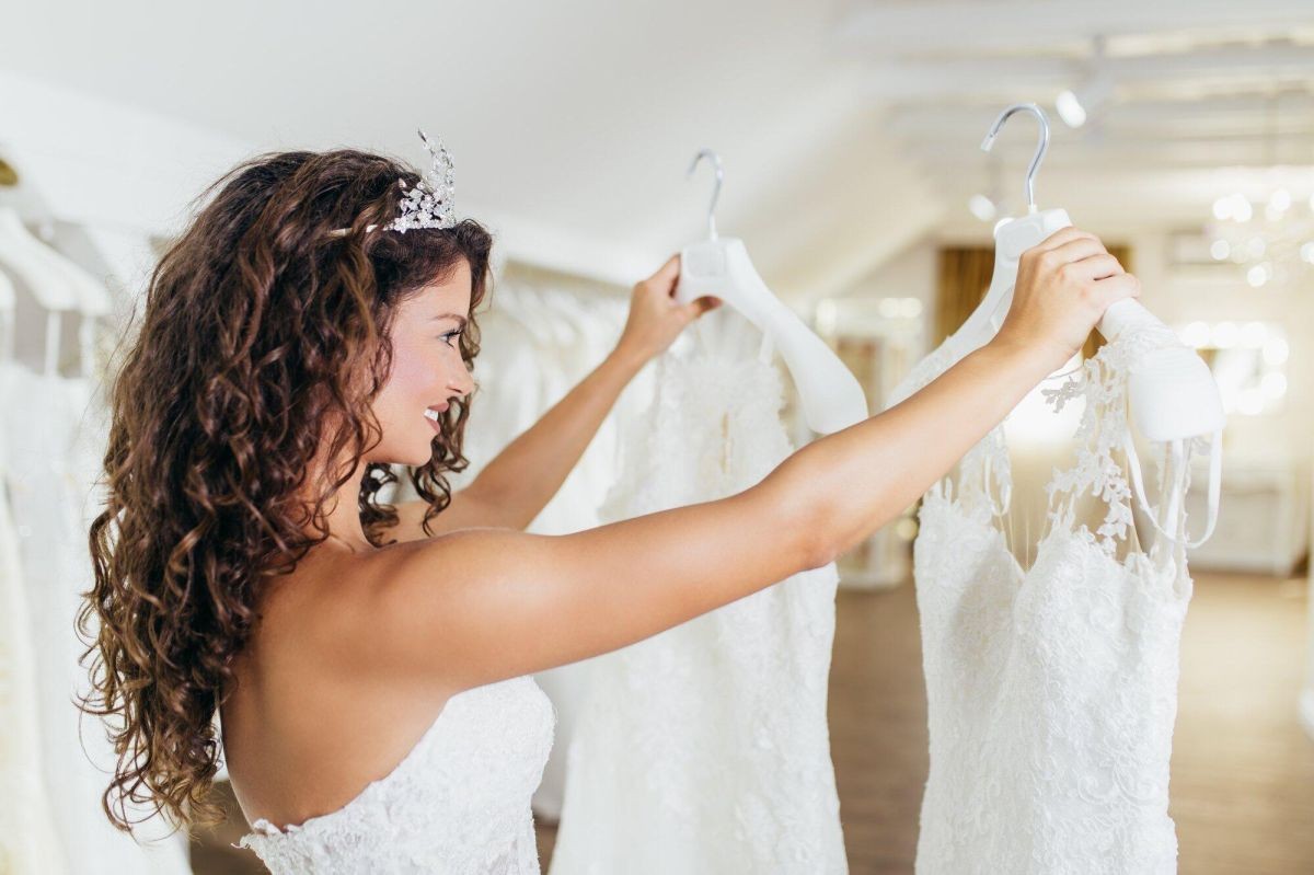 attractive-young-brunette-woman-picking-wedding-dress